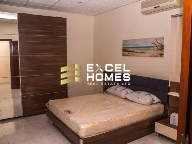 a bed with a white bedspread and a black and white bedspread