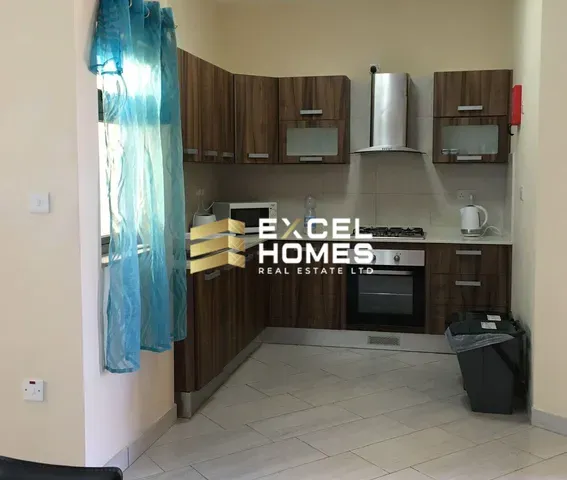 a kitchen with a refrigerator, sink, and microwave