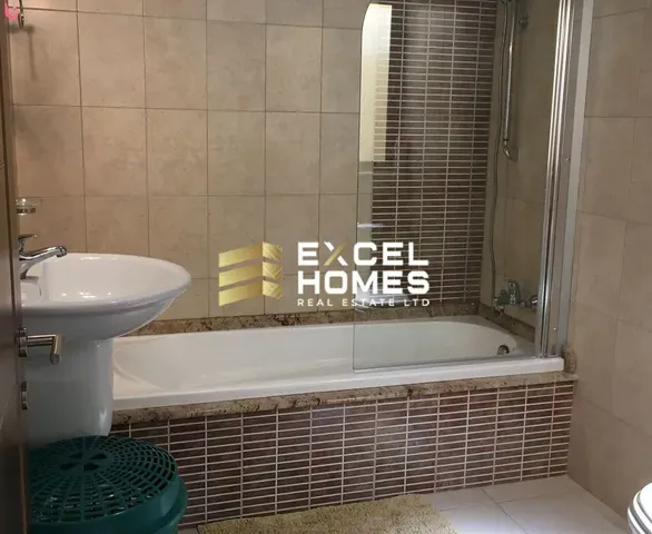 a bathroom with a tub, toilet and sink