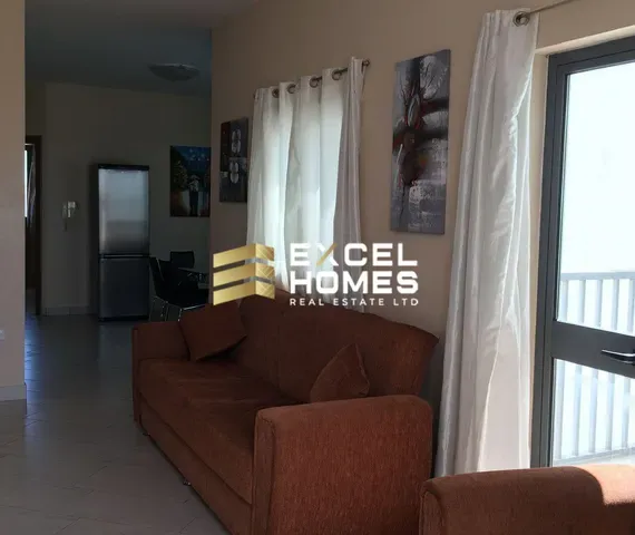 a living room with a couch, coffee table and a television