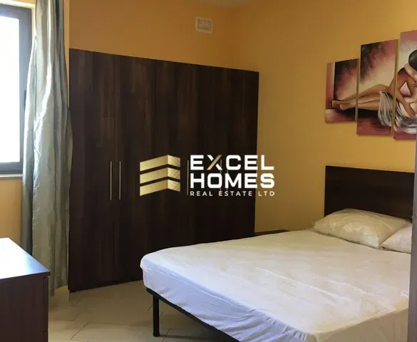 a bed with a white bedspread and a black bedspread