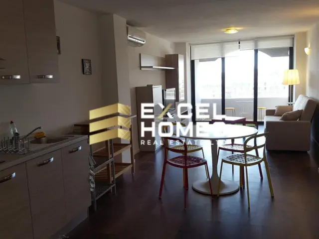 a kitchen with a table and chairs and a refrigerator