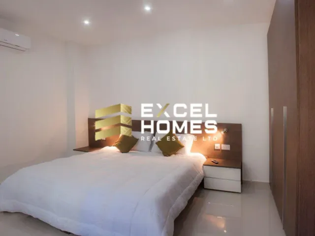 a bed with a white bedspread and a lamp