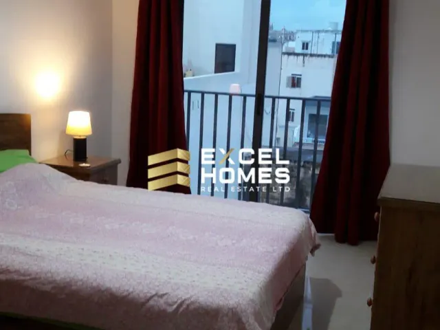 a bed room with a bed and a window