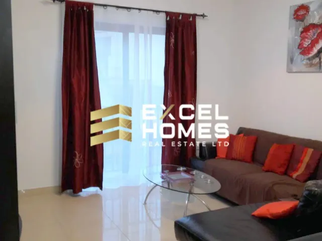 a living room with a couch, coffee table and a television