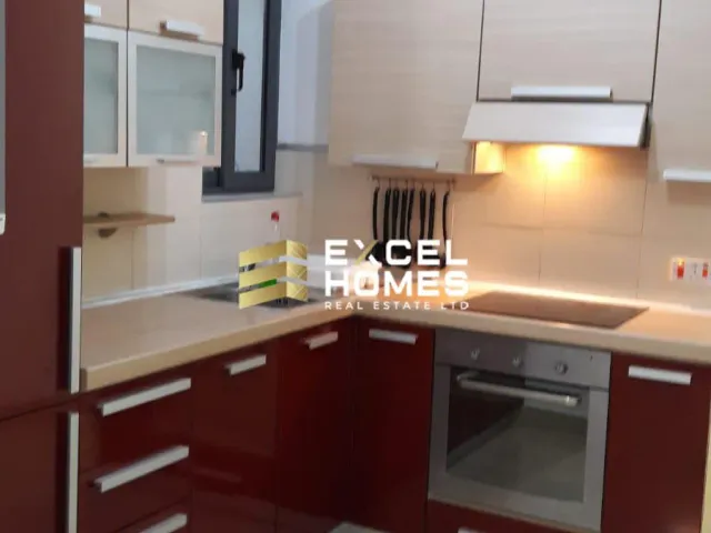 a kitchen with a stove, sink, and refrigerator