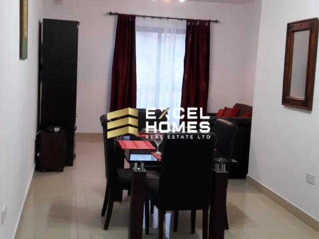 a living room with a table and chairs