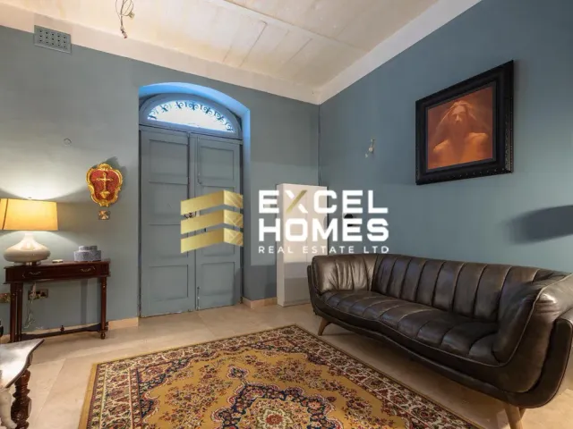 a living room with a couch, chair, and a rug