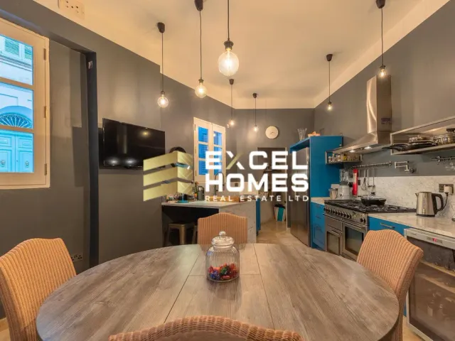 a kitchen with a table and a microwave