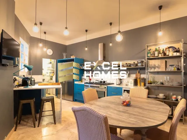 a kitchen with a table and chairs and a refrigerator