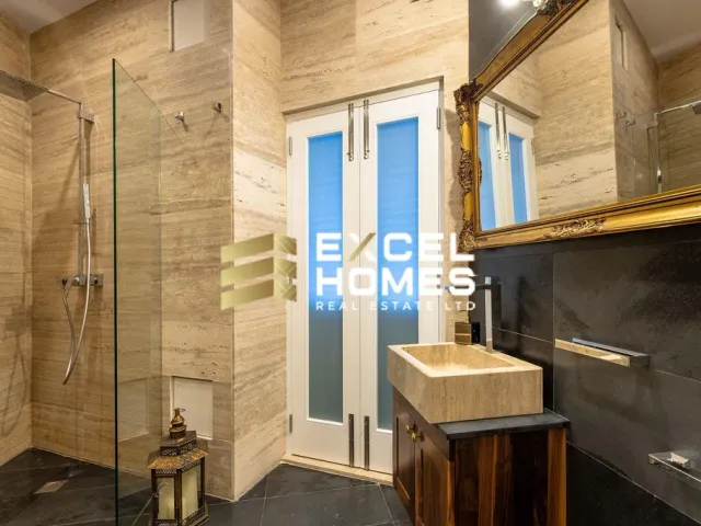 a bathroom with a shower, sink, and a window