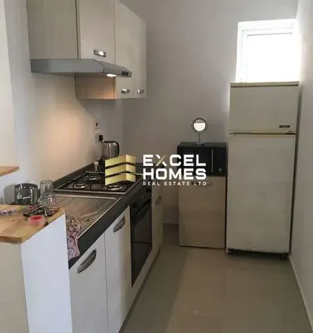 a kitchen with a refrigerator, stove, sink and a microwave