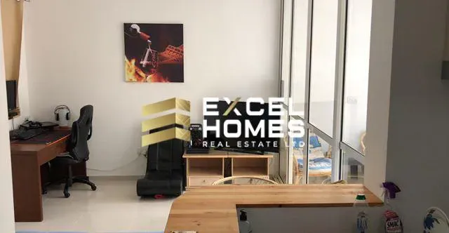 a desk with a computer and a chair