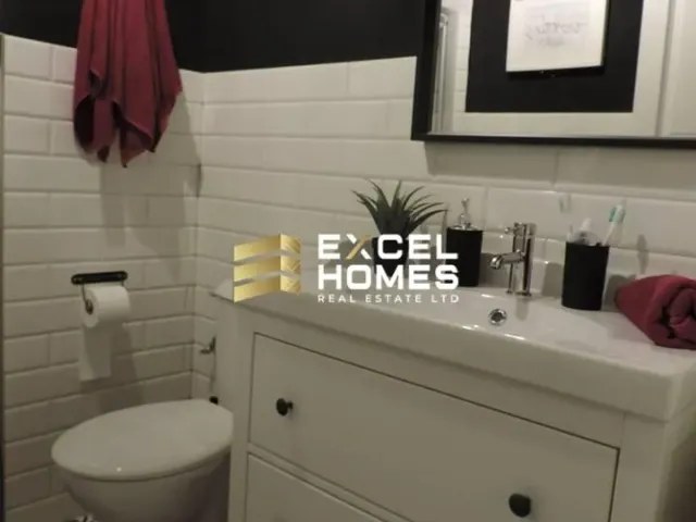 a bathroom with a toilet, sink, and mirror