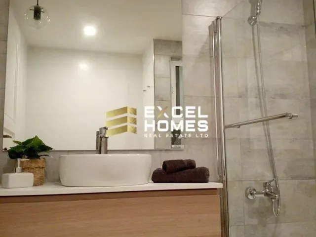 a bathroom with a tub, shower, and toilet