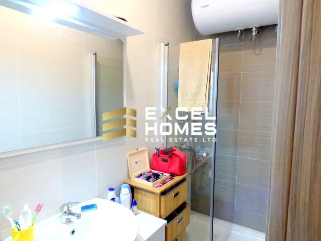 a bathroom with a toilet, sink, and shower