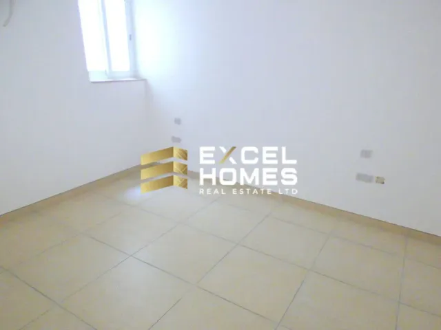 a yellow chair sitting in a room next to a wall 