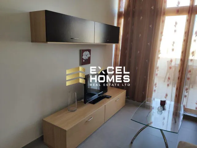 a room with a television and a desk