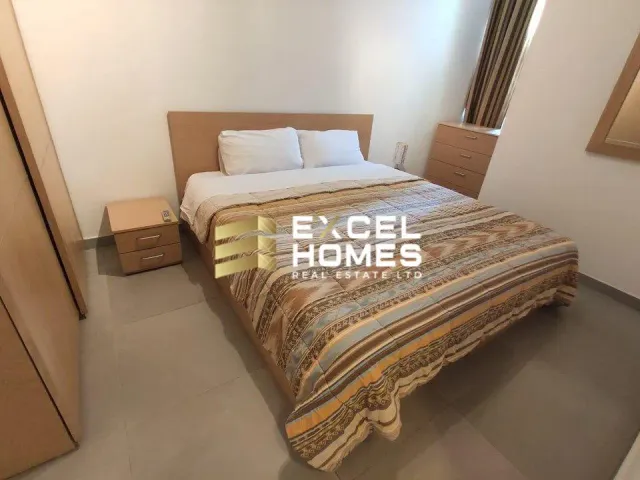 a bed with a white bedspread and pillows