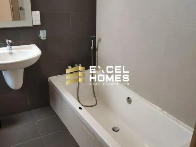 a bathroom with a tub, sink, and toilet