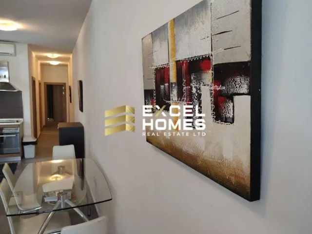 a wall with a picture of a kitchen with a refrigerator and a clock