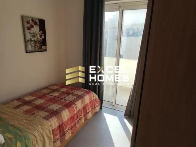 a bed with a pillow and a window