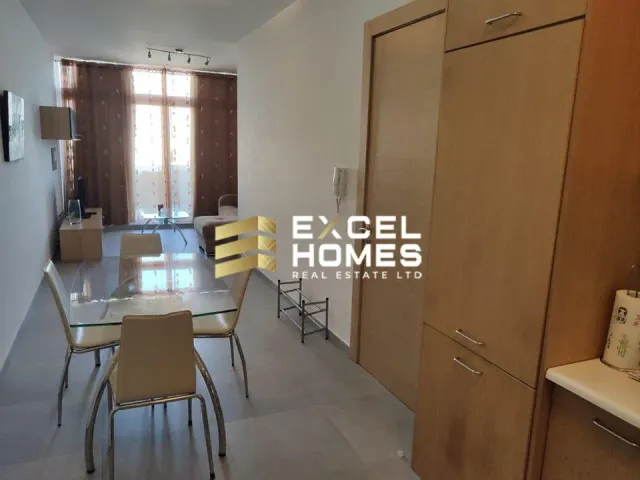 a kitchen with a table and chairs and a refrigerator