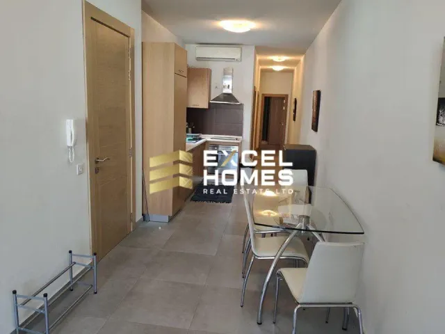 a kitchen with a sink, a refrigerator, and a door