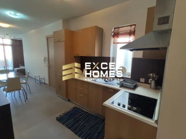 a kitchen with a microwave, refrigerator, and sink