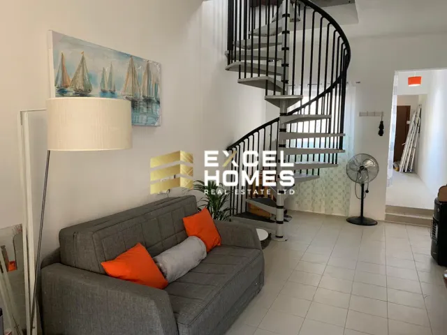 a living room with a couch, coffee table and a television