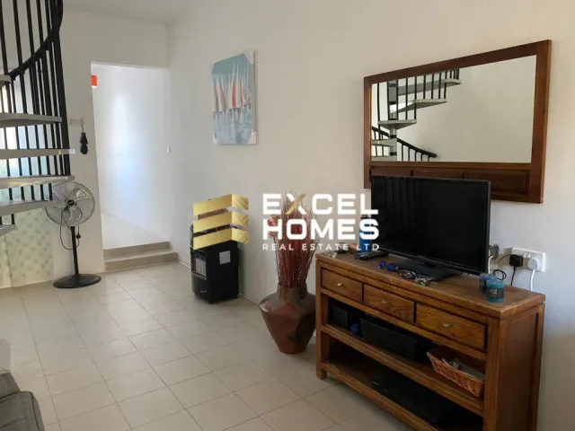 a room with a tv and a mirror