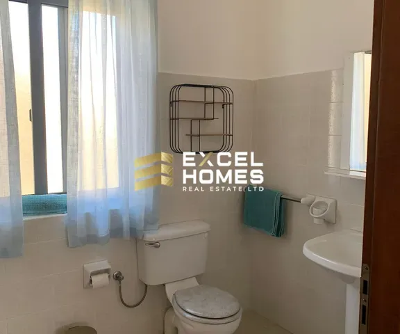 a bathroom with a toilet, sink, and shower