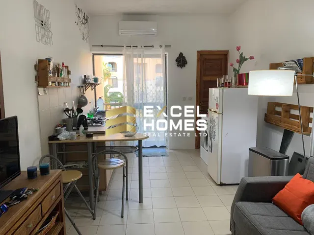 a kitchen with a refrigerator, stove, and a table