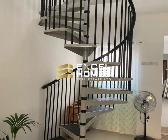 a staircase leading up to a balcony with a large mirror