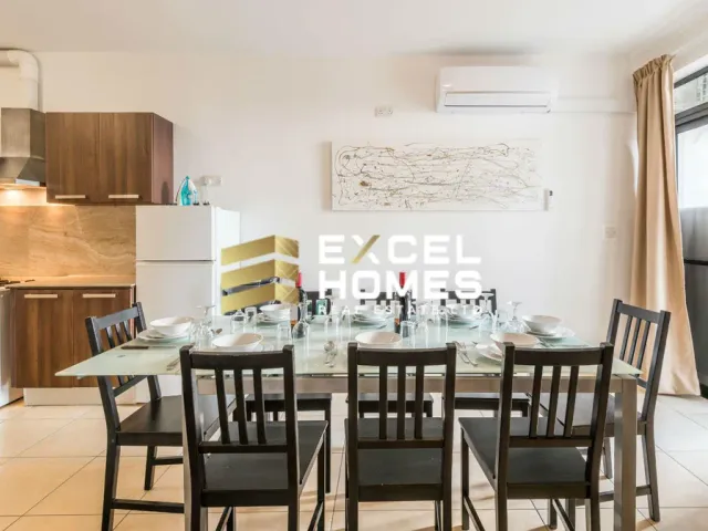 a kitchen with a table and chairs and a refrigerator