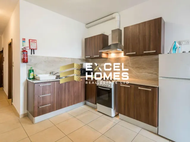 a kitchen with a stove, refrigerator, microwave and a sink