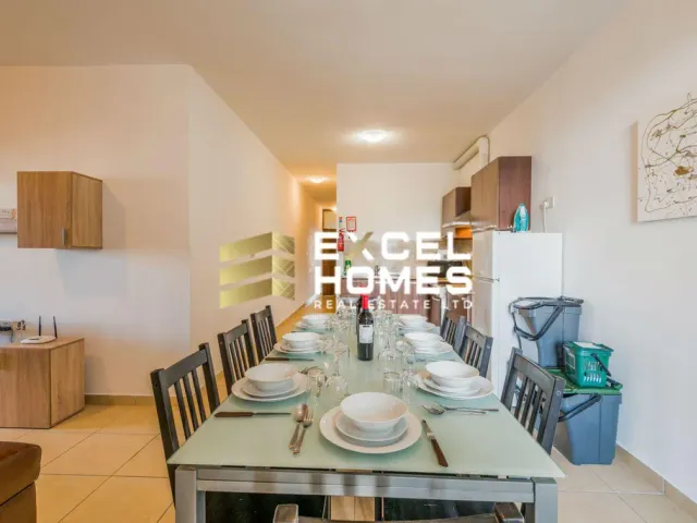 a kitchen with a table and a microwave