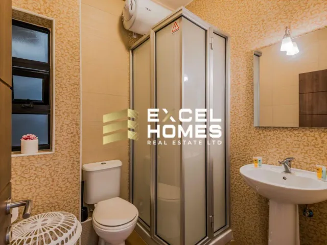 a bathroom with a toilet, sink, and shower