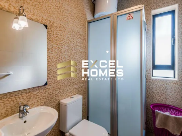 a bathroom with a shower, toilet and sink 