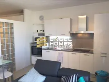 a kitchen with a refrigerator, stove, sink and a microwave