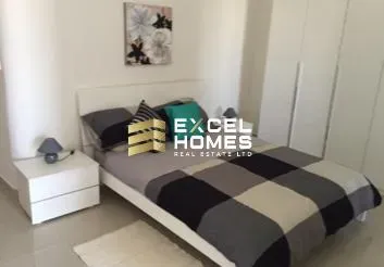 a bed with a white bedspread and a black and white bedspread