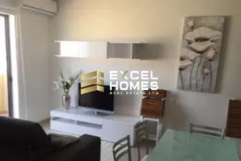 a living room with a couch, coffee table and a tv