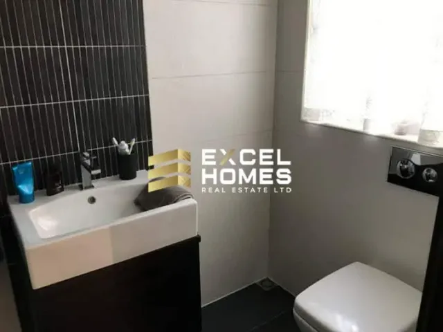 a bathroom with a toilet, sink, and mirror