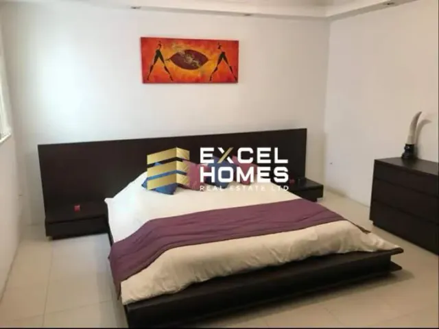 a bed with a white bedspread and a black and white bedspread