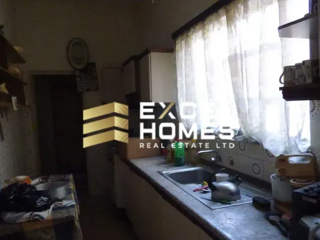 a kitchen with a window and a window blind