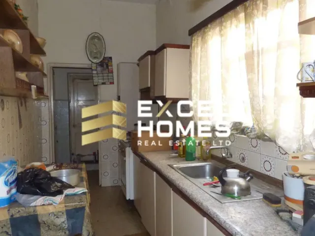 a kitchen with a sink, refrigerator, and cabinets