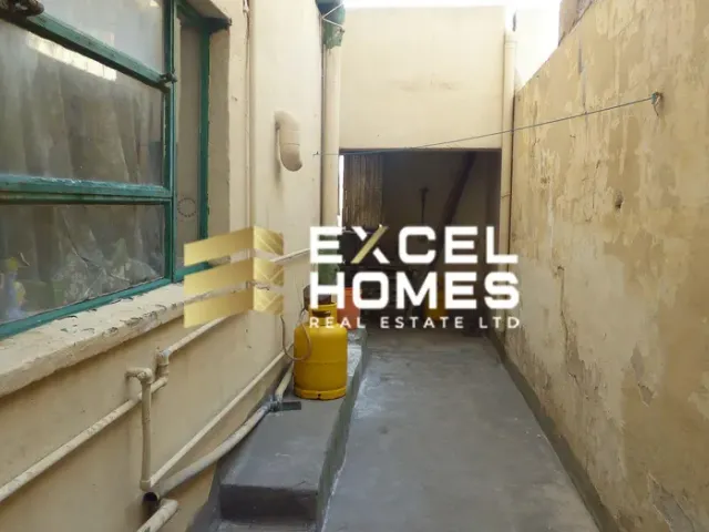 a yellow fire hydrant sitting next to a wall