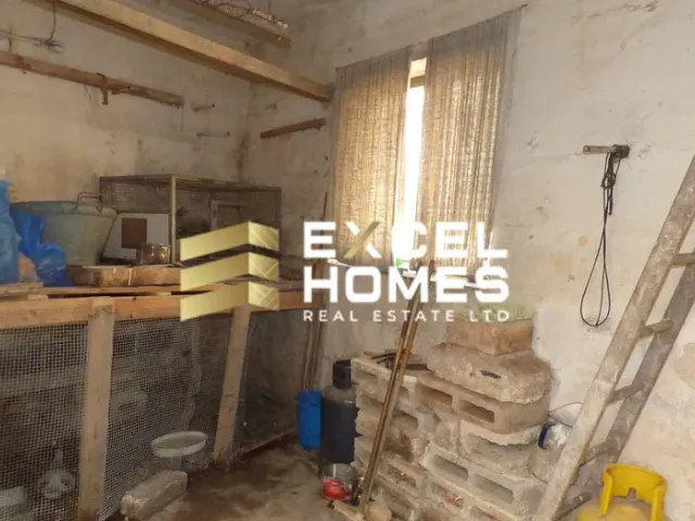 a room with a window and a wall with a pile of junk