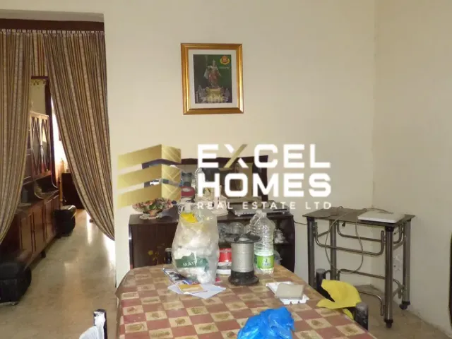 a living room with a table, chairs, and a coffee table