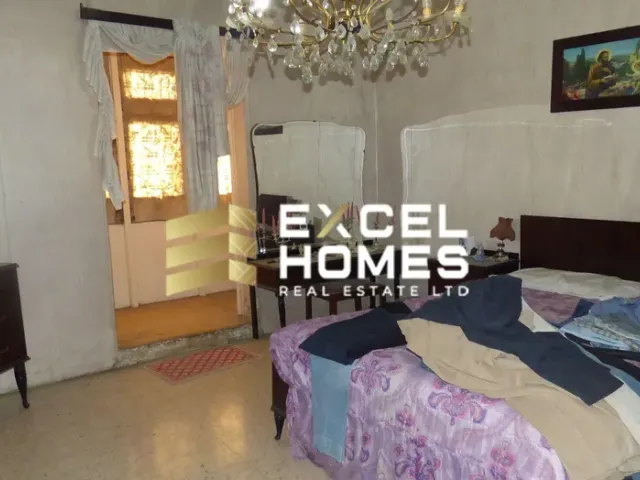 a bed room with a bed and a painting on the wall